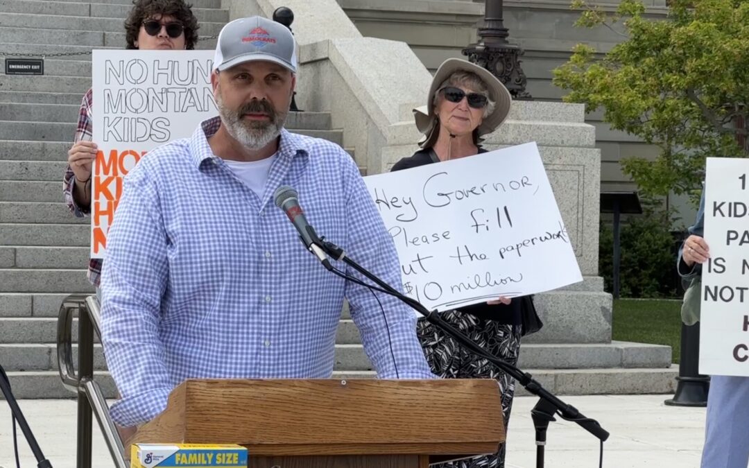 Ryan Busse speaks at a rally in July urging Gov. Greg Gianforte to accept federal funds to feed schoolchildren